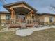 Covered front porch with stone accents, wood columns, steps, and a walkway at 15955 W 52Nd Dr, Golden, CO 80403