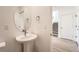 Stylish half-bath with pedestal sink, round mirror, and modern fixtures at 1294 S Algonquian St, Aurora, CO 80018