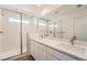 Spa-like primary bathroom boasts dual vanities, a walk-in shower, and bright lighting at 1294 S Algonquian St, Aurora, CO 80018