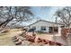 A view of the backyard deck featuring seating, a grill, and landscaping pots at 7559 Jay Ct, Arvada, CO 80003