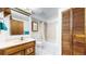 Well-lit bathroom with vanity, bathtub, and convenient closet space at 7559 Jay Ct, Arvada, CO 80003