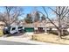 Inviting home with green garage door, showcasing ample driveway space with an RV parked nearby at 7559 Jay Ct, Arvada, CO 80003