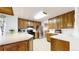 An efficient kitchen with white countertops, stainless steel appliances and wood cabinets at 7559 Jay Ct, Arvada, CO 80003