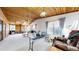 Open concept living room area with wood ceiling, carpet and large windows at 7559 Jay Ct, Arvada, CO 80003