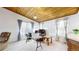 This carpeted living room has a wood ceiling and large window at 7559 Jay Ct, Arvada, CO 80003