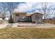 Backyard with mature trees and lawn featuring a patio, deck, and a storage shed at 8757 Estes Ct, Arvada, CO 80005