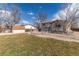 Well-maintained backyard featuring a storage shed, brick patio, and chain-link fence at 8757 Estes Ct, Arvada, CO 80005