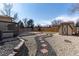 Landscaped backyard with rock garden, brick paver path, and storage shed; perfect for outdoor enjoyment at 8757 Estes Ct, Arvada, CO 80005