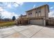 Exterior showcasing a two-story design with a large driveway and an attached garage at 8757 Estes Ct, Arvada, CO 80005