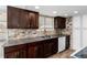 Kitchen featuring granite countertops, a stone backsplash, stainless steel appliances, and dark cabinetry at 8757 Estes Ct, Arvada, CO 80005