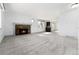 Inviting living room with fireplace, neutral carpeting, and adjacent kitchen area at 8757 Estes Ct, Arvada, CO 80005