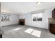 Bright living room with a brick fireplace, neutral paint, large windows, and plush gray carpeting at 8757 Estes Ct, Arvada, CO 80005