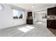 A sunny living room with a large window, neutral paint, and plush gray carpeting at 8757 Estes Ct, Arvada, CO 80005