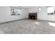 Bright living room featuring fireplace, light gray carpet, and a big window at 8757 Estes Ct, Arvada, CO 80005