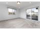 Bright living room featuring neutral carpeting and a sliding glass door to the deck at 8757 Estes Ct, Arvada, CO 80005