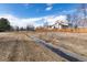 View of the property backing to a greenbelt and stream for added privacy at 8757 Estes Ct, Arvada, CO 80005