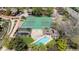Aerial view showcasing community pool and tennis courts with mature trees at 2630 Juniper Ave # 37-5, Boulder, CO 80304