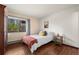 Bright bedroom featuring a cozy bed, wood floors and natural light at 2630 Juniper Ave # 37-5, Boulder, CO 80304
