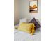 Close up on cozy bed, featuring an assortment of decorative pillows and a sunrise painting at 2630 Juniper Ave # 37-5, Boulder, CO 80304