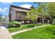 Charming brown townhome featuring a private balcony and lush green lawn at 2630 Juniper Ave # 37-5, Boulder, CO 80304