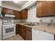 Functional kitchen featuring tiled backsplash, ample cabinets, and white appliances at 2630 Juniper Ave # 37-5, Boulder, CO 80304