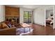 Cozy living room with fireplace, hardwood floors, and sliding doors to balcony at 2630 Juniper Ave # 37-5, Boulder, CO 80304