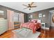 Cozy bedroom featuring a ceiling fan, wood floors, and natural light from the window at 534 E 7Th Ave # 205, Denver, CO 80203