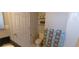 Practical half-bathroom featuring a toilet, towel rack, and shelving, providing essential amenities in a compact space at 4220 E 119Th Pl # A, Thornton, CO 80233