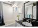 Bright bathroom featuring a tub, a white vanity with a dark countertop, and a decorative mirror for a stylish touch at 4220 E 119Th Pl # A, Thornton, CO 80233