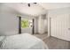 Cozy bedroom featuring a ceiling fan, a large window with curtains, and multiple closets for convenient storage solutions at 4220 E 119Th Pl # A, Thornton, CO 80233