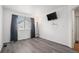 Minimalist bedroom with hardwood floors, a modern lamp, and a mounted TV at 4220 E 119Th Pl # A, Thornton, CO 80233