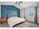 Modern bedroom featuring a decorative accent wall, hardwood floors, and ample natural light at 4220 E 119Th Pl # A, Thornton, CO 80233