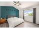 Comfortable bedroom featuring a grey bed frame, moon decorations, a ceiling fan, and a bright window with gray curtains at 4220 E 119Th Pl # A, Thornton, CO 80233