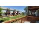 Community view from this townhome's deck with wood railings overlooking the grassy common area at 4220 E 119Th Pl # A, Thornton, CO 80233