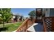 Inviting outdoor deck with wood railings, perfect for relaxation and enjoying the community's beautiful green spaces at 4220 E 119Th Pl # A, Thornton, CO 80233