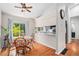 Inviting dining area with hardwood floors, a ceiling fan, and bright natural light from the window at 4220 E 119Th Pl # A, Thornton, CO 80233