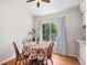 Bright dining area featuring hardwood floors, a ceiling fan, and a large window with curtains at 4220 E 119Th Pl # A, Thornton, CO 80233