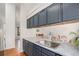 Spacious kitchen with an island, painted cabinets, and stainless steel sink at 4220 E 119Th Pl # A, Thornton, CO 80233