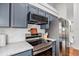 Modern kitchen featuring stainless steel appliances and dark painted cabinets at 4220 E 119Th Pl # A, Thornton, CO 80233