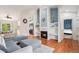 Inviting living room boasts a fireplace, custom shelving, and hardwood floors at 4220 E 119Th Pl # A, Thornton, CO 80233