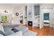 Cozy living area with fireplace, built-in shelves, hardwood floors, and lots of natural light from the exterior at 4220 E 119Th Pl # A, Thornton, CO 80233