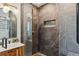 Luxurious bathroom featuring a glass shower, stone tile, and gold hardware and fixtures at 3059 N Humboldt St, Denver, CO 80205