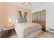 Comfortable bedroom featuring a light pink accent wall, dark hardwood floors, and custom closet doors at 3059 N Humboldt St, Denver, CO 80205