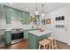 Modern kitchen with green cabinets, stainless steel appliances, and a convenient center island at 3059 N Humboldt St, Denver, CO 80205