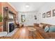 Inviting living room featuring a fireplace, hardwood floors, and ample natural light at 3059 N Humboldt St, Denver, CO 80205