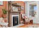 Cozy living room with a decorative fireplace, comfortable chair, and bright window view at 3059 N Humboldt St, Denver, CO 80205