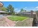 Spacious backyard with green lawn, wooden fence, and mature trees, perfect for outdoor activities at 3832 S Quebec St, Denver, CO 80237