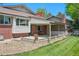 Backyard patio with brick accents and access to a well-maintained lawn at 3832 S Quebec St, Denver, CO 80237