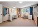 Cozy bedroom with carpet, desk, bookcase, and a window that provides plenty of natural light at 3832 S Quebec St, Denver, CO 80237