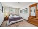 Comfortable bedroom featuring patterned accent wall and natural light at 3832 S Quebec St, Denver, CO 80237